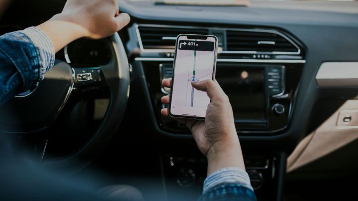 Smart phone mapping while in car - stock photo