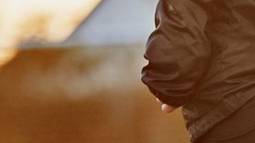 Close up of female footballer's footwork to avoid being tackled, in warm evening light