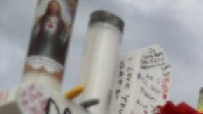 EL PASO, TEXAS - AUGUST 06: A woman touches a cross at a makeshift memorial for victims outside Walmart, near the scene of a mass shooting which left at least 22 people dead, on August 6, 2019 in El Paso, Texas. A 21-year-old white male suspect remains in custody in El Paso, which sits along the U.S.-Mexico border. President Donald Trump plans to visit the city August 7. (Photo by Mario Tama/Getty Images)