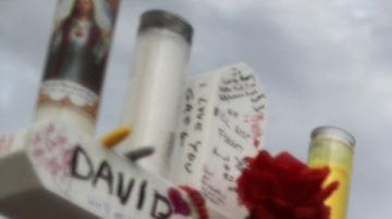 EL PASO, TEXAS - AUGUST 06: A woman touches a cross at a makeshift memorial for victims outside Walmart, near the scene of a mass shooting which left at least 22 people dead, on August 6, 2019 in El Paso, Texas. A 21-year-old white male suspect remains in custody in El Paso, which sits along the U.S.-Mexico border. President Donald Trump plans to visit the city August 7. (Photo by Mario Tama/Getty Images)