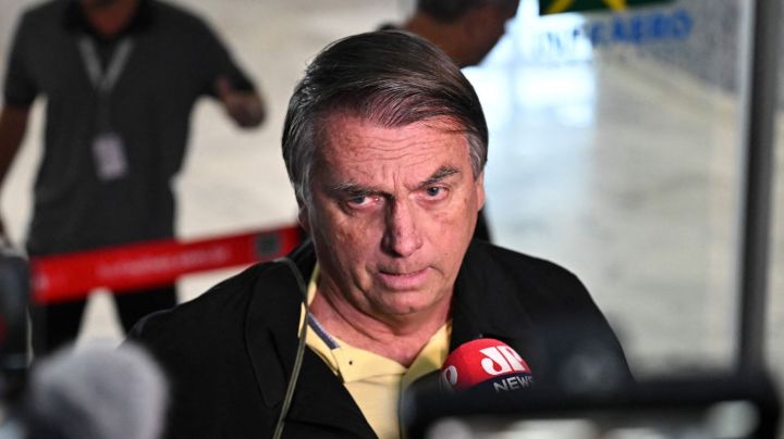 Former Brazilian President Jair Bolsonaro speaks to members of the media upon arrival at the Santos Dumont Airport in Rio de Janeiro, Brazil, on June 29, 2023. Judges will continue delivering verdicts Thursday on charges that far-right ex-president Jair Bolsonaro broke the law with his unproven allegations against Brazil's election system, which could see him banned from holding office for eight years. (Photo by MAURO PIMENTEL / AFP) (Photo by MAURO PIMENTEL/AFP via Getty Images)