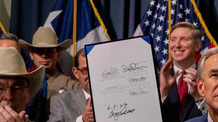 AUSTIN, TEXAS - JUNE 08: Texas Gov. Greg Abbott displays a signed bill during a news conference on June 08, 2023 in Austin, Texas. Gov. Abbott and Texas Department of Public Safety Director Steve McCraw joined bill authors, sponsors, legislators and law enforcement members in the signing of bills designated towards enhancing border security along the southern border. (Photo by Brandon Bell/Getty Images)