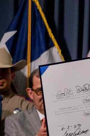 AUSTIN, TEXAS - JUNE 08: Texas Gov. Greg Abbott displays a signed bill during a news conference on June 08, 2023 in Austin, Texas. Gov. Abbott and Texas Department of Public Safety Director Steve McCraw joined bill authors, sponsors, legislators and law enforcement members in the signing of bills designated towards enhancing border security along the southern border. (Photo by Brandon Bell/Getty Images)