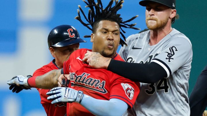 CLEVELAND, OH - AUGUST 05: Jose Ramirez #11 of the Cleveland Guardians is held by Michael Kopech #34 of the Chicago White Sox during a fight in the sixth inning at Progressive Field on August 05, 2023 in Cleveland, Ohio. (Photo by Ron Schwane/Getty Images)