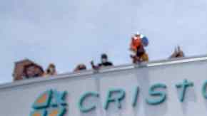 Graduation student waving at school.