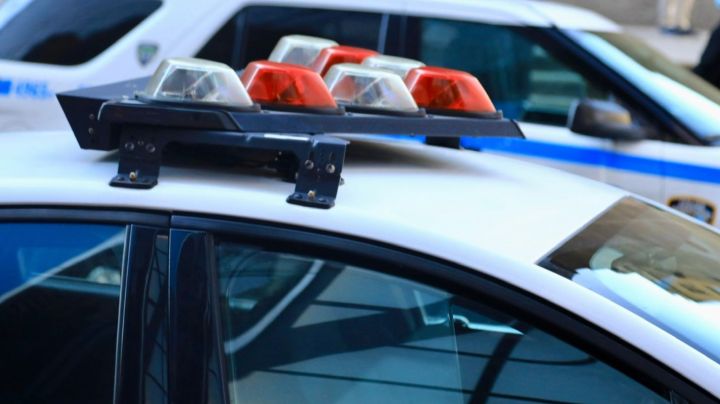 Police vehicles with overhead strobe lights at a crime scene - stock photo