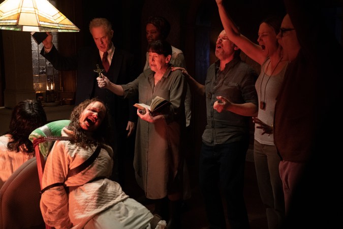 (from lower left, clockwise) Angela Fielding (Lidya Jewett, back to camera), Katherine (Olivia O’Neill), Pastor Don Revans (Raphael Sbarge), Doctor Beehibe (Okwui Okpokwasili), Ann (Ann Dowd), Tony (Norbert Leo Butz), Miranda (Jennifer Nettles) and Stuart (Danny McCarthy) in The Exorcist: Believer, directed by David Gordon Green.