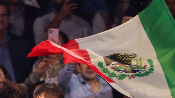 LAS VEGAS, NEVADA - SEPTEMBER 30: A Mexican flag is waved over Canelo Alvarez as he enters the ring for his super middleweight title fight against Jermell Charlo at T-Mobile Arena on September 30, 2023 in Las Vegas, Nevada. Alvarez won by unanimous decision. (Photo by Ethan Miller/Getty Images)