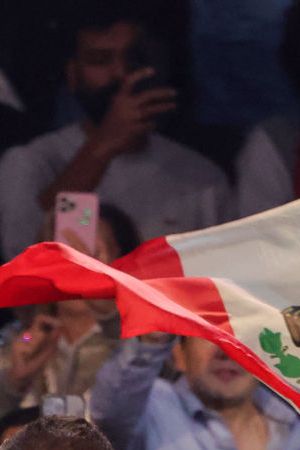 LAS VEGAS, NEVADA - SEPTEMBER 30: A Mexican flag is waved over Canelo Alvarez as he enters the ring for his super middleweight title fight against Jermell Charlo at T-Mobile Arena on September 30, 2023 in Las Vegas, Nevada. Alvarez won by unanimous decision. (Photo by Ethan Miller/Getty Images)