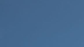 Bottom View of Passenger Airplane Flying Over Waving Mexico Flag On Pole.