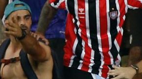 RIO DE JANEIRO, BRAZIL - NOVEMBER 21: Police officers armed with batons clash with fans as the match is delayed due to the incidents prior to a FIFA World Cup 2026 Qualifier match between Brazil and Argentina at Maracana Stadium on November 21, 2023 in Rio de Janeiro, Brazil. (Photo by Wagner Meier/Getty Images)
