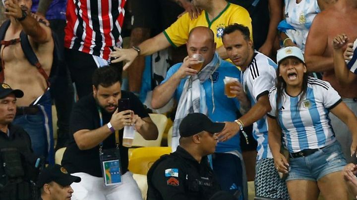 RIO DE JANEIRO, BRAZIL - NOVEMBER 21: Police officers armed with batons clash with fans as the match is delayed due to the incidents prior to a FIFA World Cup 2026 Qualifier match between Brazil and Argentina at Maracana Stadium on November 21, 2023 in Rio de Janeiro, Brazil. (Photo by Wagner Meier/Getty Images)