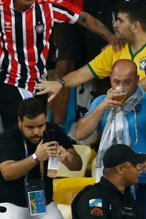 RIO DE JANEIRO, BRAZIL - NOVEMBER 21: Police officers armed with batons clash with fans as the match is delayed due to the incidents prior to a FIFA World Cup 2026 Qualifier match between Brazil and Argentina at Maracana Stadium on November 21, 2023 in Rio de Janeiro, Brazil. (Photo by Wagner Meier/Getty Images)