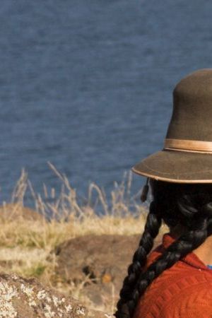 Subject: A Peruvian woman spinning the wool of a baby Vicuna, a South American camelid in the family of a Llama, produces one of the finest wool in the world