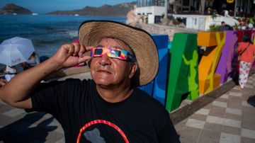 MAZATLAN, MEXICO - APRIL 08: A person watches the total solar eclipse at the beach on April 8, 2024 in Mazatlán, Mexico. Millions of people have flocked to areas across North America that are in the path of totality in order to experience a total solar eclipse. During the event, the moon will pass in between the sun and the Earth, appearing to block the sun. (Photo by Miguel Martínez Corona/ObturadorMX/Getty Images)