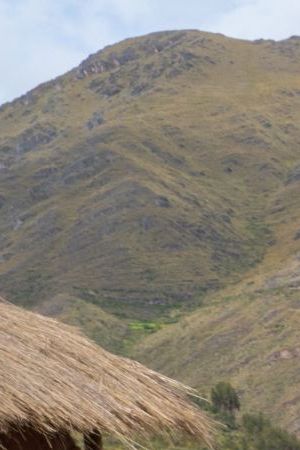 Three local female weavers in colourful traditional local dress including festooned hats, weaving colourful alpaca wool on the ground, Chumbe Community, Lamay, Sacred Valley, Peru (3 Model Releases and Property Release) - stock photo