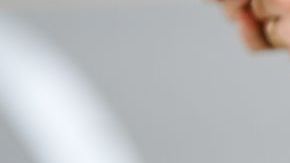 NEW YORK, NEW YORK - SEPTEMBER 11: A guest wears a navy blue wool pullover, gold rings, a green shiny leather Telfar handbag, brown beige wide legs pants, outside Ulla Johnson, during New York Fashion Week, on September 11, 2022 in New York City. (Photo by Edward Berthelot/Getty Images)