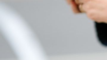 NEW YORK, NEW YORK - SEPTEMBER 11: A guest wears a navy blue wool pullover, gold rings, a green shiny leather Telfar handbag, brown beige wide legs pants, outside Ulla Johnson, during New York Fashion Week, on September 11, 2022 in New York City. (Photo by Edward Berthelot/Getty Images)