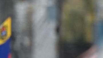 Police officers stand guard next to demonstrators waving Venezuelan flags during a protest against Venezuelan President Nicolas Maduro's government in Caracas on July 29, 2024, a day after the Venezuelan presidential election. Protests erupted in parts of Caracas Monday against the re-election victory claimed by Venezuelan President Nicolas Maduro but disputed by the opposition and questioned internationally, AFP journalists observed. (Photo by Yuri CORTEZ / AFP) (Photo by YURI CORTEZ/AFP via Getty Images)
