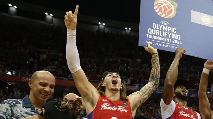 Puerto Rico's players celebrate with the ticket to the 2024 Paris Olympics after defeating Lithuania during the 2024 FIBA Men's Olympic Qualifying Tournament basketball match in San Juan, Puerto Rico, on July 7, 2024. (Photo by Ricardo ARDUENGO / AFP) (Photo by RICARDO ARDUENGO/AFP via Getty Images)