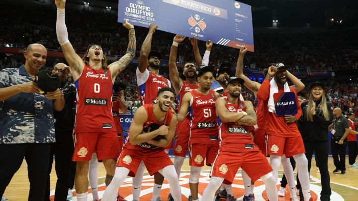 Puerto Rico's players celebrate with the ticket to the 2024 Paris Olympics after defeating Lithuania during the 2024 FIBA Men's Olympic Qualifying Tournament basketball match in San Juan, Puerto Rico, on July 7, 2024. (Photo by Ricardo ARDUENGO / AFP) (Photo by RICARDO ARDUENGO/AFP via Getty Images)