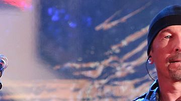 NEW YORK, NY - DECEMBER 01:  The Edge and Chris Martin of Coldplay perform as "U2 - 1" in a surprise concert by (RED) to mark World AIDS Day in Times Square on December 1, 2014 in New York City.  (Photo by Taylor Hill/FilmMagic)