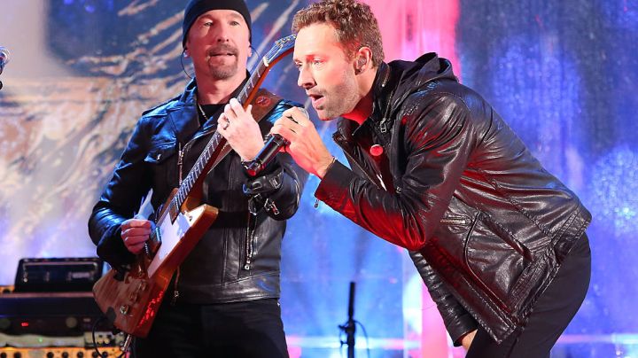 NEW YORK, NY - DECEMBER 01: The Edge and Chris Martin of Coldplay perform as "U2 - 1" in a surprise concert by (RED) to mark World AIDS Day in Times Square on December 1, 2014 in New York City. (Photo by Taylor Hill/FilmMagic)
