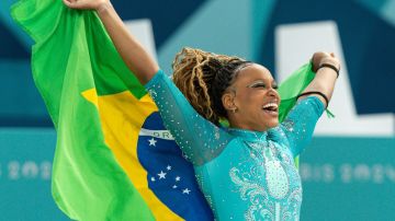 PARIS, FRANCE - AUGUST 5: Gold medal winner Rebeca Andrade of Brazil celebrates with the brazilian flag while women´s floor exercise final on day ten of the Olympic Games Paris 2024 at Bercy Arena on August 05, 2024 in Paris, France. (Photo by Rodolfo Buhrer/Eurasia Sport Images/Getty Images)