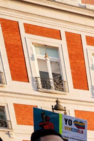 Demonstrators hold a giant national flag of Venezuela during a protest against Venezuelan President Nicolas Maduro's disputed victory in the country's Presidential elections, at Puerta del Sol, Madrid, on August 3, 2024. (Photo by OSCAR DEL POZO / AFP) (Photo by OSCAR DEL POZO/AFP via Getty Images)