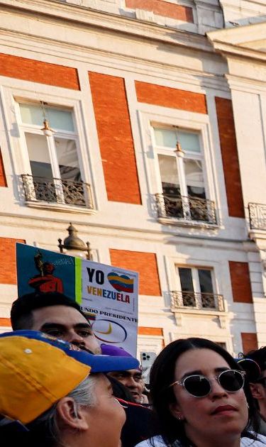 Demonstrators hold a giant national flag of Venezuela during a protest against Venezuelan President Nicolas Maduro's disputed victory in the country's Presidential elections, at Puerta del Sol, Madrid, on August 3, 2024. (Photo by OSCAR DEL POZO / AFP) (Photo by OSCAR DEL POZO/AFP via Getty Images)