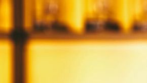 Barman making cocktail at night club bar - Bartender pouring alcohol from shaker into martini glass - Beverage life style concept