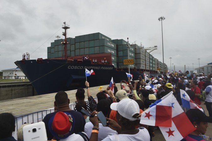 Chinese-chartered merchant ship Cosco Shipping Panama crosses the new Agua Clara Locks during the inauguration of the expansion of the Panama Canal in Colon, 80 km from Panama City on June 26, 2016. A giant Chinese-chartered freighter nudged its way into the expanded Panama Canal on Sunday to mark the completion of nearly a decade of work forecast to boost global trade. / AFP / RODRIGO ARANGUA (Photo credit should read RODRIGO ARANGUA/AFP via Getty Images)