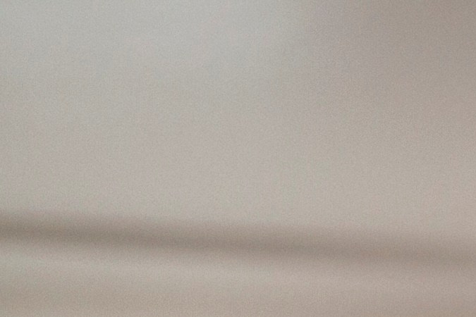 Woman kissing grandmother cooking in kitchen - stock photo