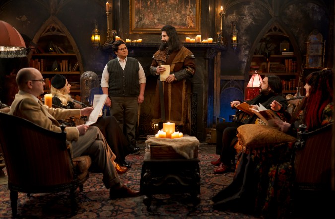 “WHAT WE DO IN THE SHADOWS” -- “The Finale” -- Season 6, Episode 11 (Airs Dec 16) — Pictured (L-R): Mark Proksch as Colin Robinson, Kristen Schaal as The Guide, Harvey Guillén as Guillermo, Kayvan Novak as Nandor, Matt Berry as Laszlo, Natasia Demetriou as Nadja. CR: Russ Martin/FX