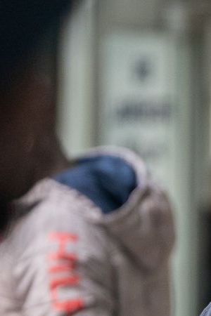 NEW YORK, NEW YORK - JUNE 6: An ICE agent monitors hundreds of asylum seekers being processed upon entering the Jacob K. Javits Federal Building on June 6, 2023 in New York City. New York City has provided sanctuary to over 46,000 asylum seekers since 2013, when the city passed a law prohibiting city agencies from cooperating with federal immigration enforcement agencies unless there is a warrant for the person's arrest.(Photo by David Dee Delgado/Getty Images)