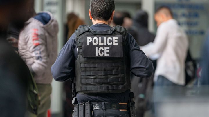 NEW YORK, NEW YORK - JUNE 6: An ICE agent monitors hundreds of asylum seekers being processed upon entering the Jacob K. Javits Federal Building on June 6, 2023 in New York City. New York City has provided sanctuary to over 46,000 asylum seekers since 2013, when the city passed a law prohibiting city agencies from cooperating with federal immigration enforcement agencies unless there is a warrant for the person's arrest.(Photo by David Dee Delgado/Getty Images)