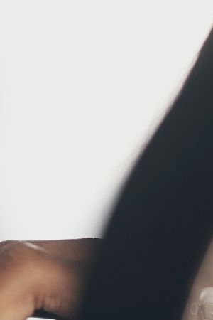 Shot of a young South Asian woman applying makeup while filming a beauty tutorial at home