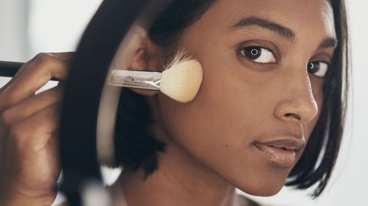 Shot of a young South Asian woman applying makeup while filming a beauty tutorial at home