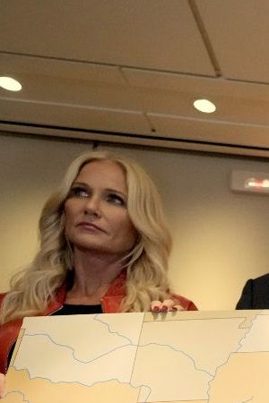 President Donald Trump, from right, speaks to reporters accompanied by Interior Secretary Doug Burgum and Burgum's wife Kathryn Burgum, aboard Air Force One where Trump signed a proclamation declaring Feb. 9 Gulf of America (Gulf of Mexico) Day, as he travels from West Palm Beach, Fla. to New Orleans, Sunday, Feb. 9, 2025. (AP Photo/Ben Curtis)