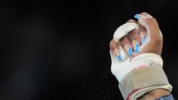Jordan Chiles, of the United States, celebrates after performing on the uneven bars during the women's artistic gymnastics team finals round at Bercy Arena at the 2024 Summer Olympics, Tuesday, July 30, 2024, in Paris, France. (AP Photo/Natacha Pisarenko)