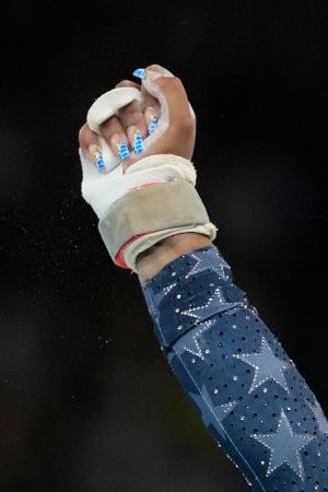 Jordan Chiles, of the United States, celebrates after performing on the uneven bars during the women's artistic gymnastics team finals round at Bercy Arena at the 2024 Summer Olympics, Tuesday, July 30, 2024, in Paris, France. (AP Photo/Natacha Pisarenko)