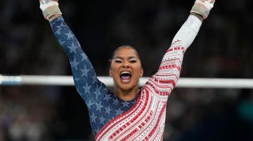 Jordan Chiles, of the United States, celebrates after performing on the uneven bars during the women's artistic gymnastics team finals round at Bercy Arena at the 2024 Summer Olympics, Tuesday, July 30, 2024, in Paris, France. (AP Photo/Natacha Pisarenko)