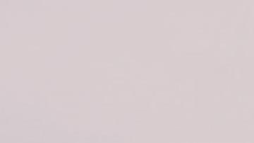 Beautiful shot of a bow of the boat on the sea with hills and a cloudy in the background