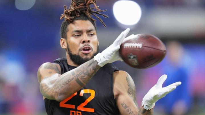 Miami running back Damien Martinez runs a drill at the NFL football scouting combine in Indianapolis, Saturday, March 1, 2025. (AP Photo/Michael Conroy)
