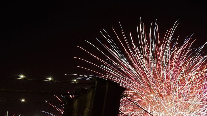 FILE - In this July 4, 2019 file photo, fireworks light up the sky above the Brooklyn Bridge during Macy's Fourth of July fireworks show in New York. The Macy's Fourth of July fireworks show will return to New York City this year. (AP Photo/Frank Franklin II, File)