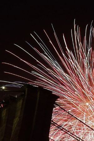 FILE - In this July 4, 2019 file photo, fireworks light up the sky above the Brooklyn Bridge during Macy's Fourth of July fireworks show in New York. The Macy's Fourth of July fireworks show will return to New York City this year. (AP Photo/Frank Franklin II, File)
