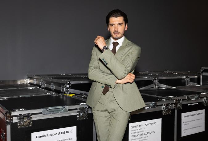 Yon González leaning against crates