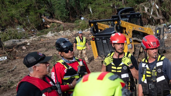 A crew of firefighters from Ciudad Acuna, Mexico, gather for a briefing as they aid in search and rescue efforts near the Guadalupe River after a flash flood swept through the area Monday, July 7, 2025, in Ingram, Texas. (AP Photo/Eli Hartman)