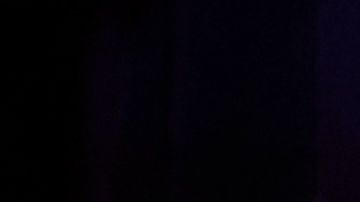 Cristela Alonzo on stage wearing a black dress