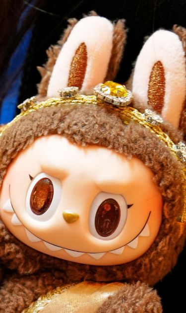 Diep Nguyen shows a Labubu doll to media during the opening of Germany's first shop for Labubu plush dolls in Berlin, Germany, Friday, July 25, 2025. (AP Photo/Markus Schreiber)